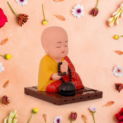 Solar Buddha statue with moving head and hand, ideal for car dashboards or office desks.