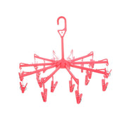 Close-up of the clothes clips hanger securely holding baby clothes for quick drying.