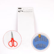 Compact sewing kit displaying assorted threads, needles, and a thimble.