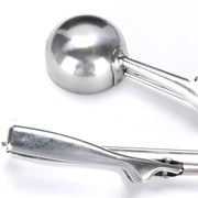 Ice cream scoop placed on a kitchen counter, ready to serve.