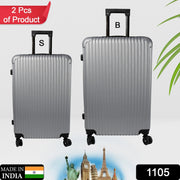 Two hard case trolley bags, big and small, in striking multi-colors, ready for travel.