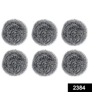 Heavy-duty stainless steel scrubber tackling tough grease on utensils.