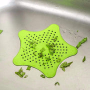 Star-shaped sink strainer in a kitchen sink, preventing clogs.