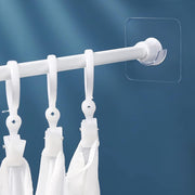 Adhesive curtain rod holder in use on wall for curtains or towels