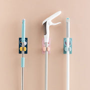 Multiple self-adhesive mop and broom holders neatly arranged on a wall.
