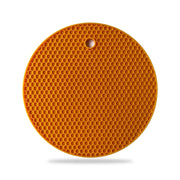 Durable silicone hot mat shown resisting high temperatures from a pan.