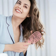 Side profile of the curved hair brush showing its unique shape.
