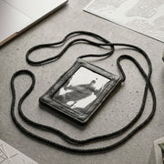Close-up of the black PU leather neck wallet showing the clear ID window