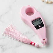 Close-up of pink digital mantra jaap counter with button and LCD screen pooja accessories