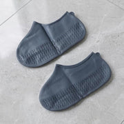 Grey silicone rain shoe cover on white background