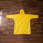 Folded yellow hooded rain poncho, highlighting its portability and compact size.